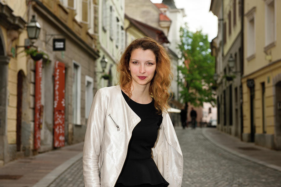 Grinning Attractive Woman Standing On Cobblestone Street Of Uppe Photograph
