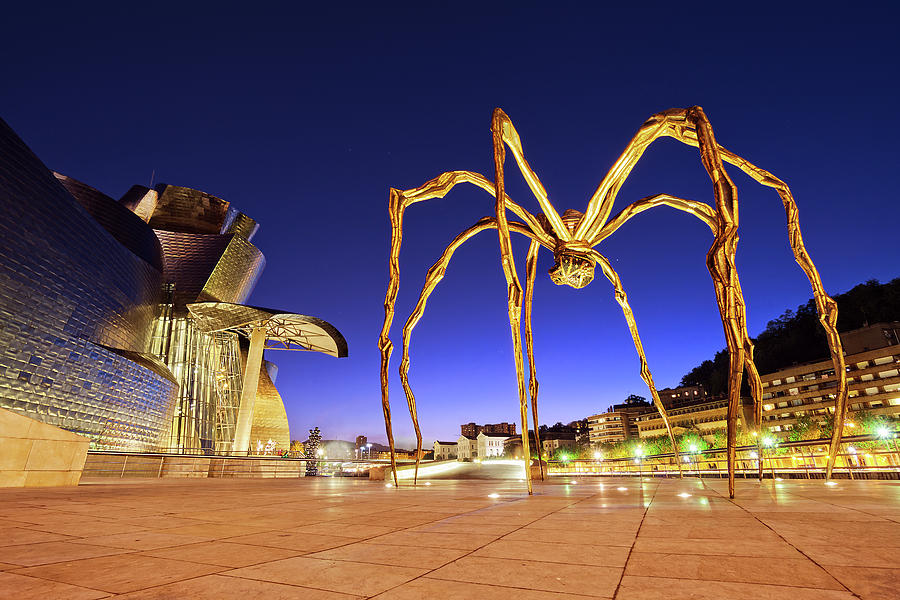 Guggenheim museum and spider at night in Bilbao Photograph by Mikel Martinez de Osaba