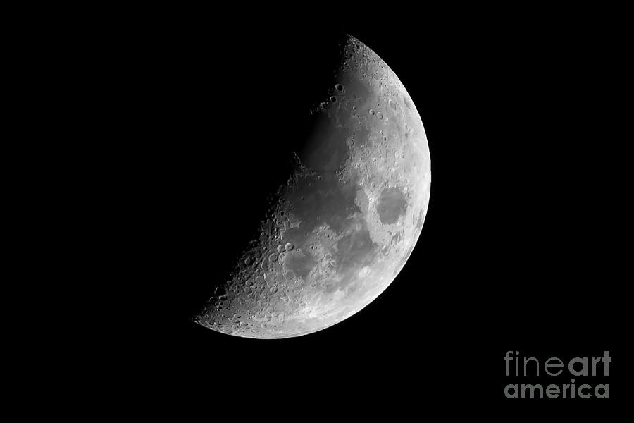 Half earth moon with craters  Photograph by Simon Bratt