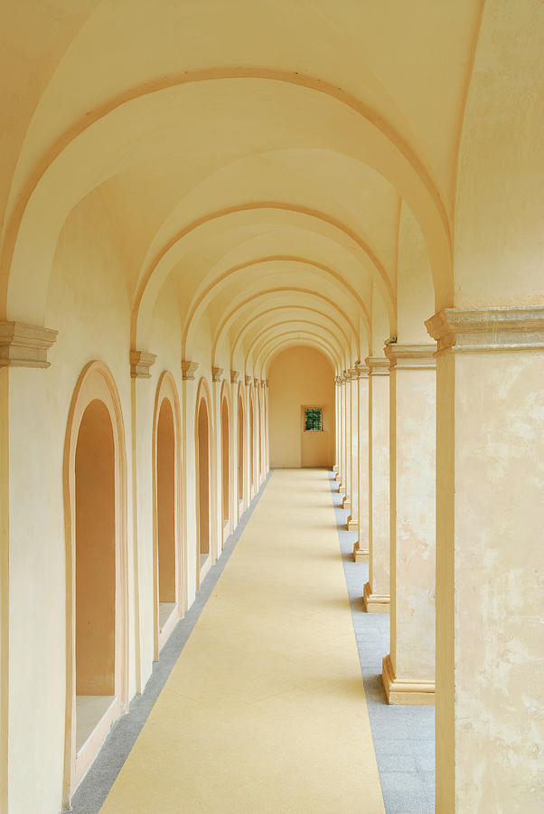 Hallway with arches at La Rocca Spoleto leading to a window of g ...