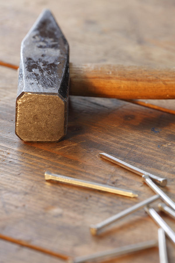 Hammer and nails on a wooden workbench Photograph by Ulrich Kunst And Bettina Scheidulin