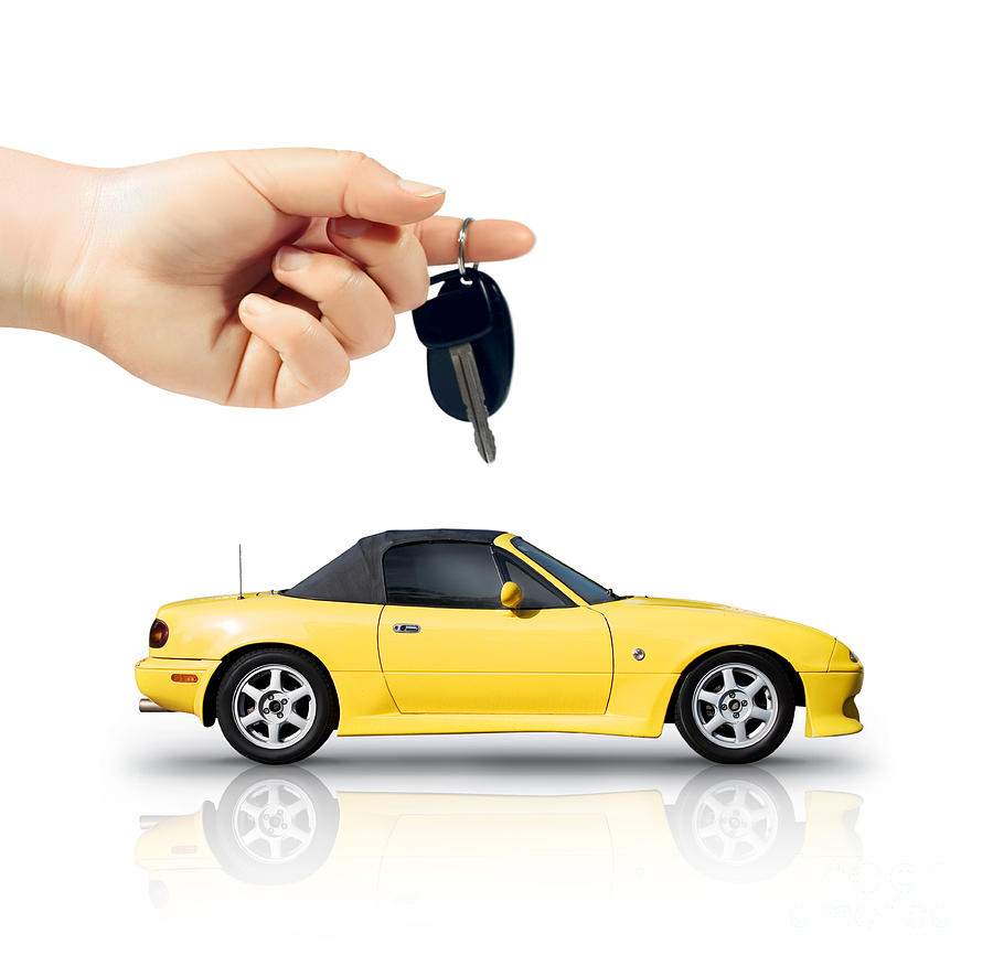 Hand Holding Key To Yellow Sports Car Photograph