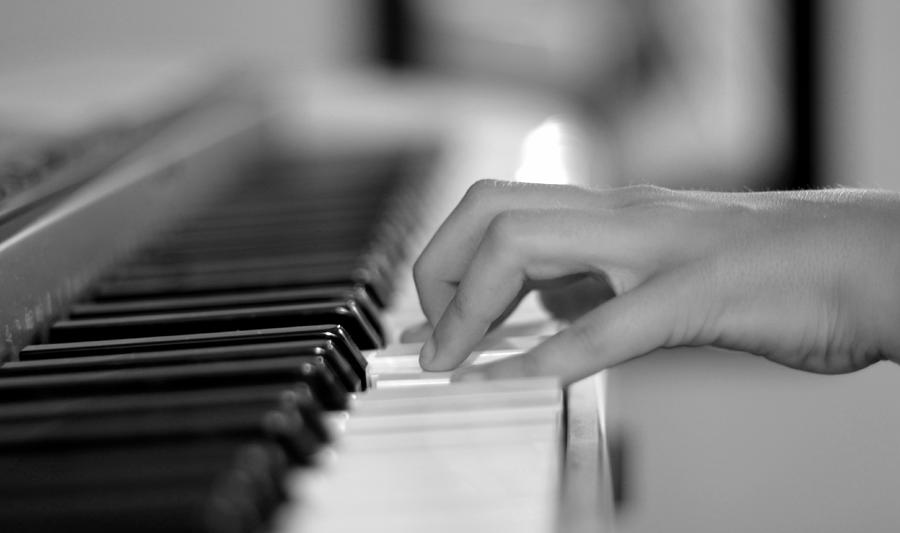 Hand on piano keyboard Photograph by Serena King