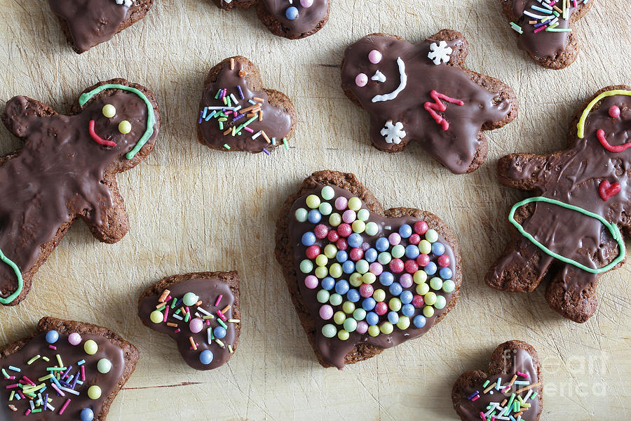 Christmas Photograph - Handmade decorated gingerbread heart and people figures by Michal Bednarek