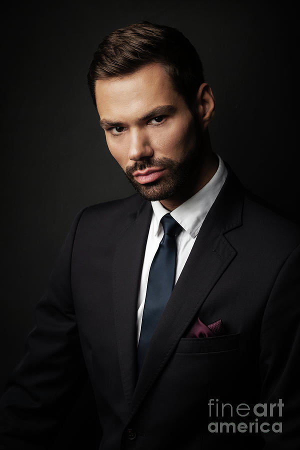 Handsome young businessman portrait on black background Photograph by Michal Bednarek
