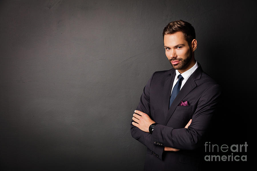 Handsome young businessman standing confident on black Photograph by Michal Bednarek