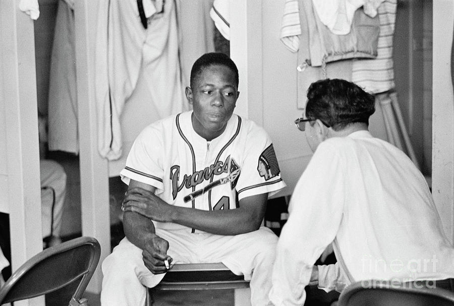 Hank Aaron in the locker room, 1958 T-Shirt by The Harrington