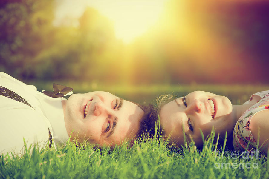 Happy couple in love smiling while lying on summer grass Photograph by Michal Bednarek