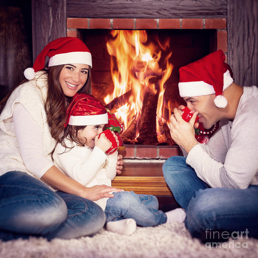 Happy family near fireplace Photograph by Anna Om