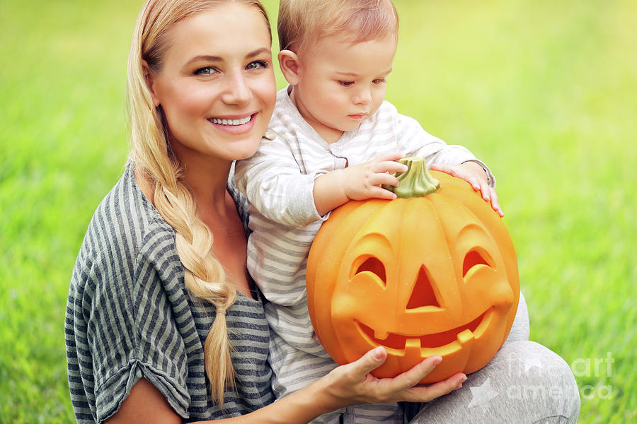Happy family with Halloween pumpkin Photograph by Anna Om