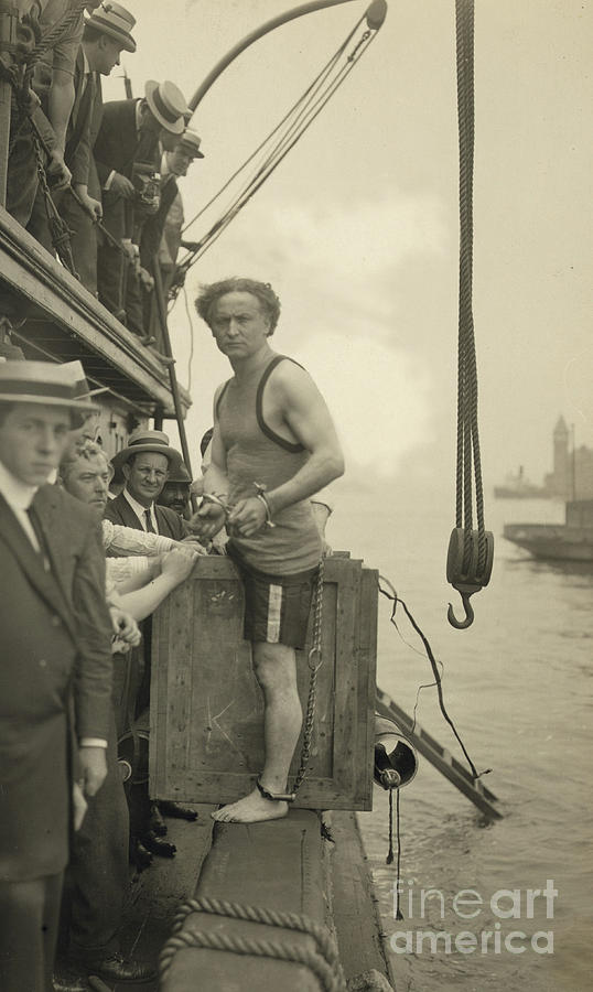Harry Houdini stepping into a crate that will be lowered into New York Harbor, 1912 Photograph by American School