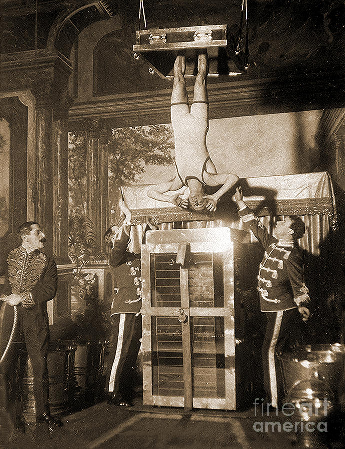 Harry Houdini suspended above a tank of water  Photograph by American School