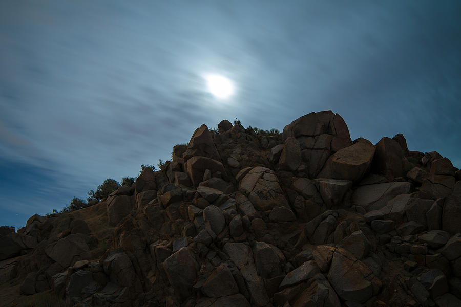 High Desert Rock Outcropping with Full Moon and Moving Clouds Photograph by Brian Ball