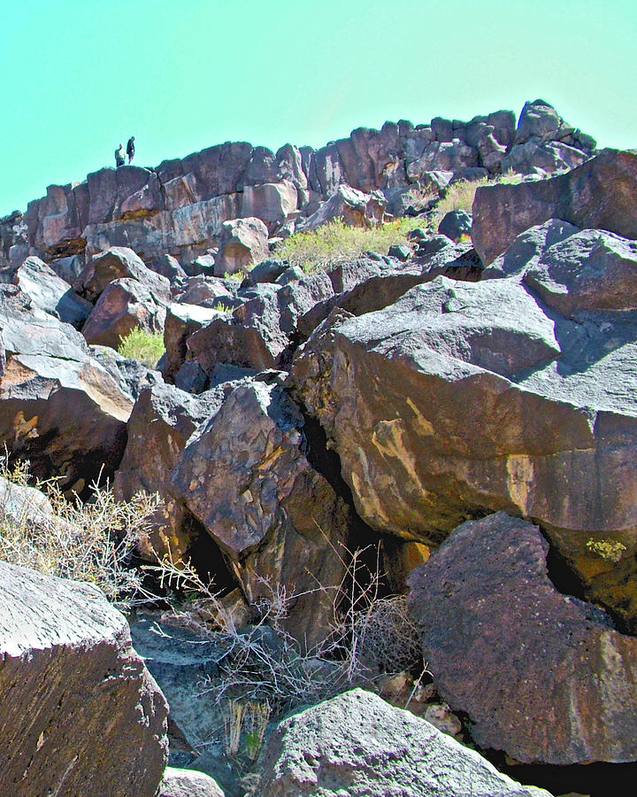 Hikers above Boca Negra Canyon in Petroglyph National Monument in Albuquerque, New Mexico Photograph by Ruth Hager