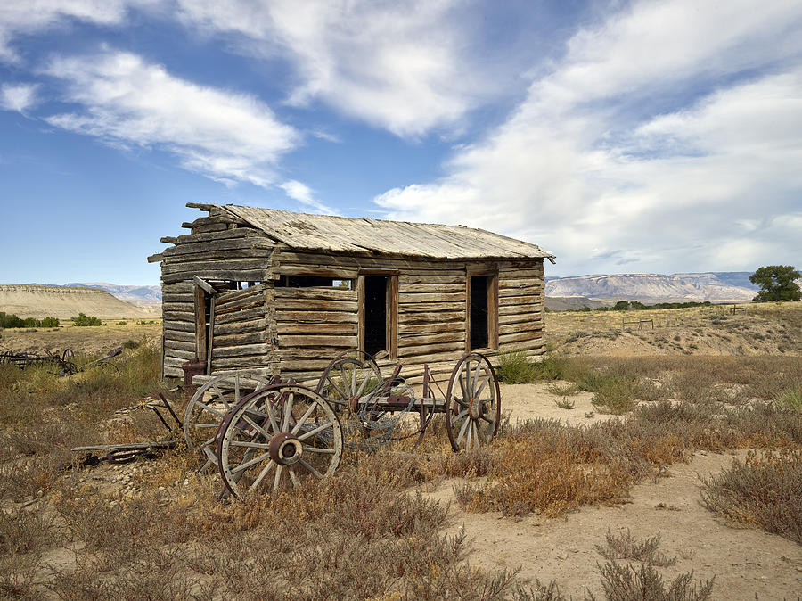 Historic Cabin And Buckboard Wheels In Big Horn County In Wyoming Photograph