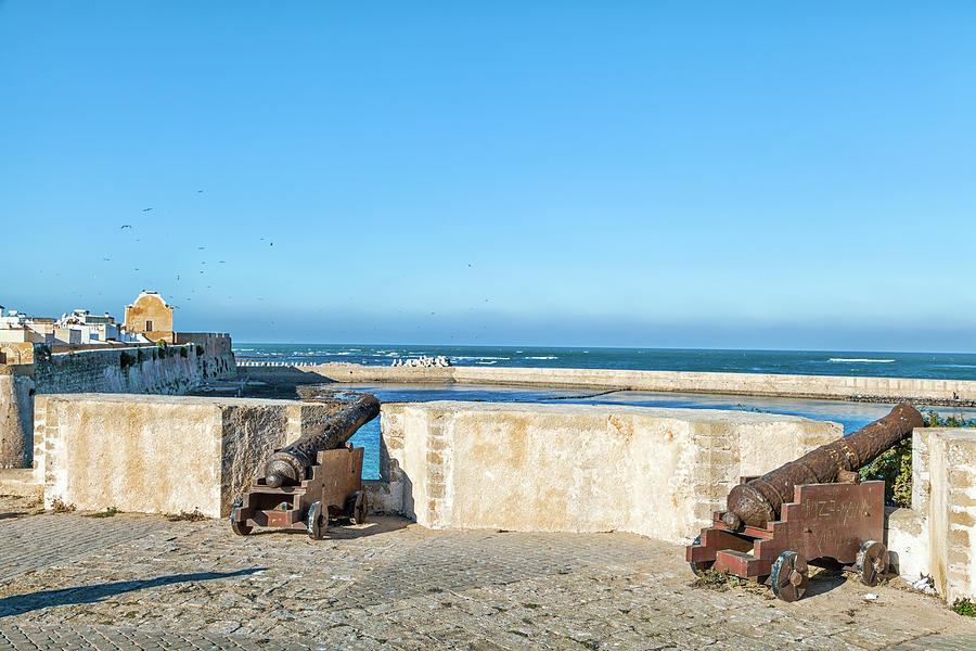 historic guns standing in the old historic portuguese fortress city El Jadida in Morocco Photograph by Gina Koch