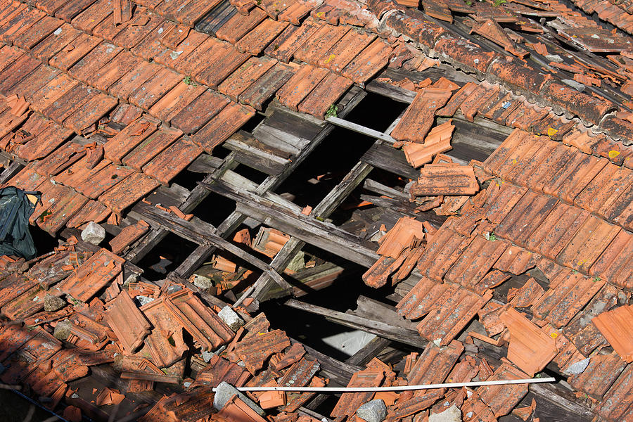 Hole in Damaged Tiled Roof Photograph by Artur Bogacki