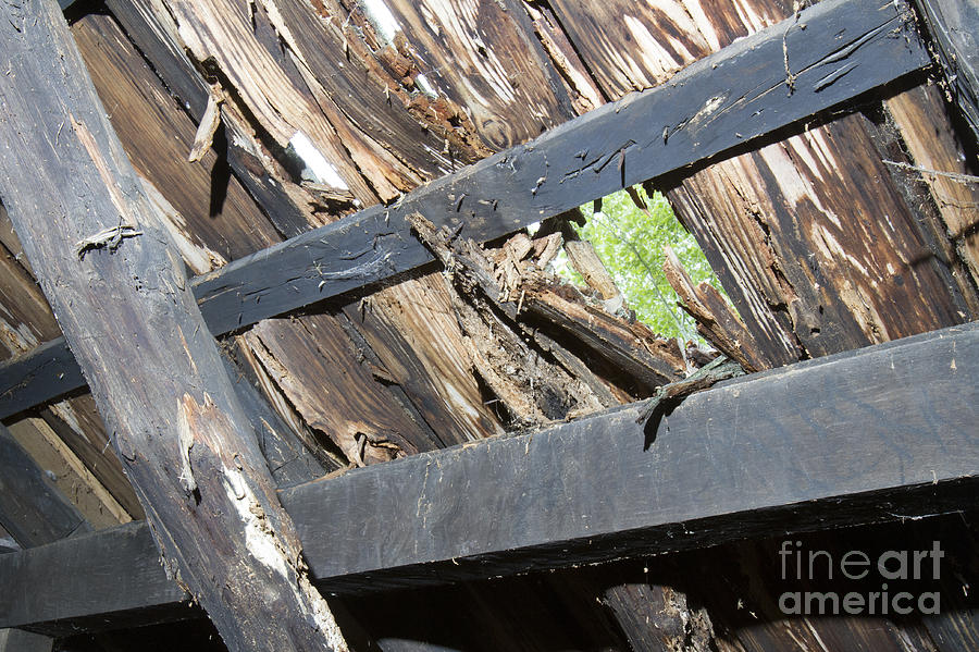 Hole in wooden roof Photograph by Karen Foley