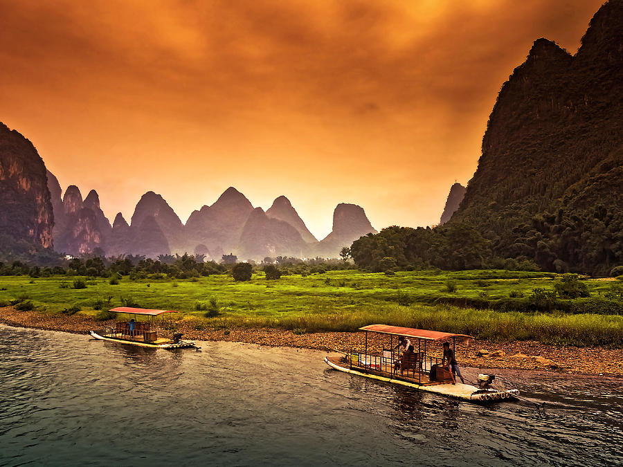 Home boat in red evening glow-China Guilin scenery Lijiang River in Yangshuo Photograph by Artto Pan