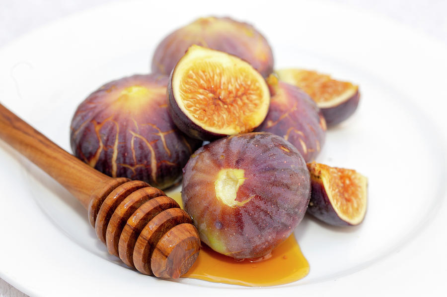 Honey and figs on a plate Photograph by Paul Cowan