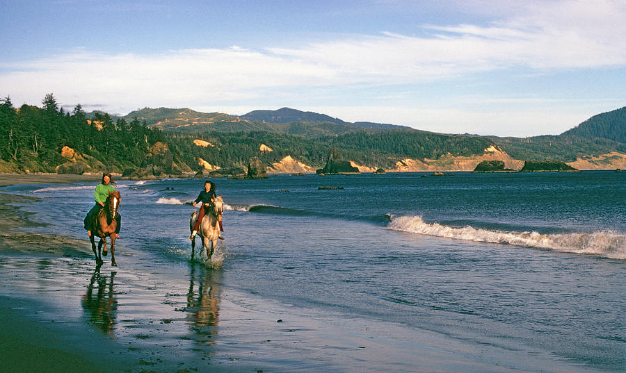 Horseback riding on Oregon Beach Photograph by Buddy Mays