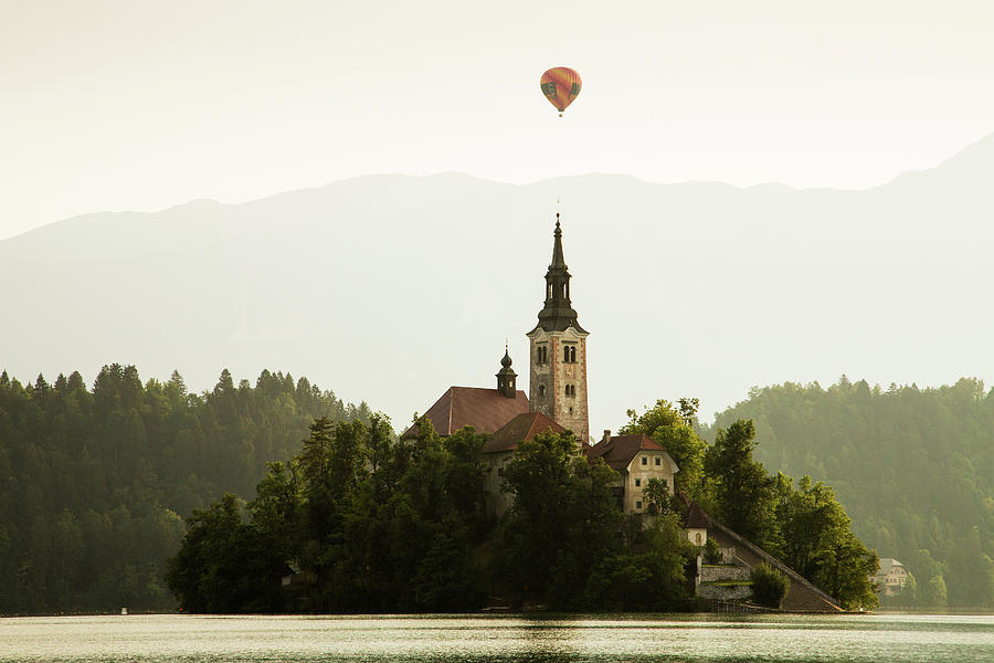 Hot air Balloon over Lake Bled and the Island church Photograph by Ian Middleton