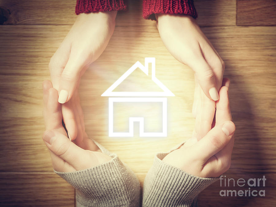 House symbol inside hands circle. Concept of home insurance Photograph by Michal Bednarek