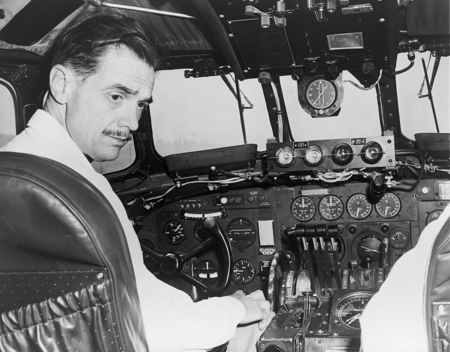 Portrait Photograph - Howard Hughes Seated In The Cockpit Twa by Everett