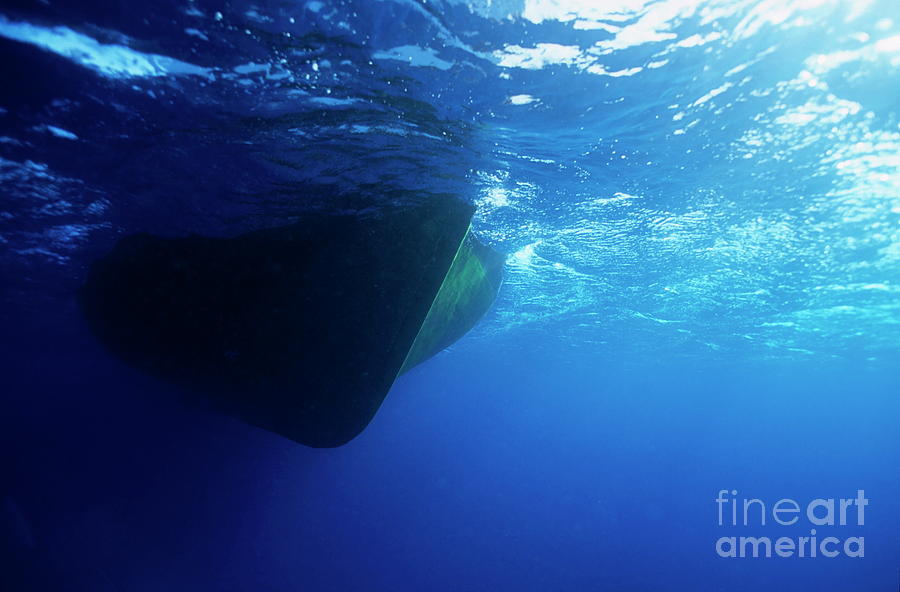 Hull of a boat is seen from underwater Photograph by Sami Sarkis