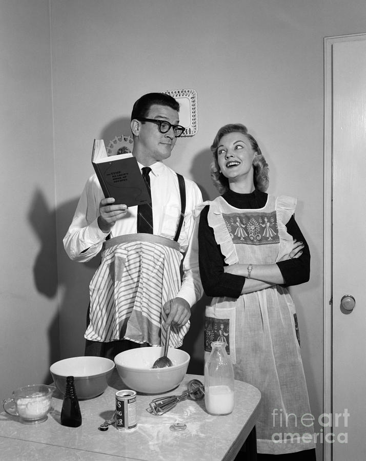 Husband Trying To Cook While Wife Looks Photograph by Debrocke/ClassicStock