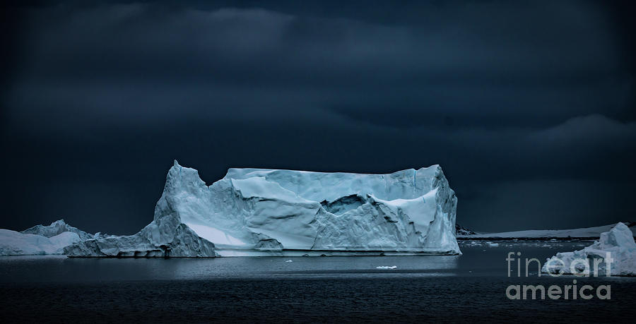 Iceberg in dark cloudy sky Photograph by Philippe Tulula And Julie ...