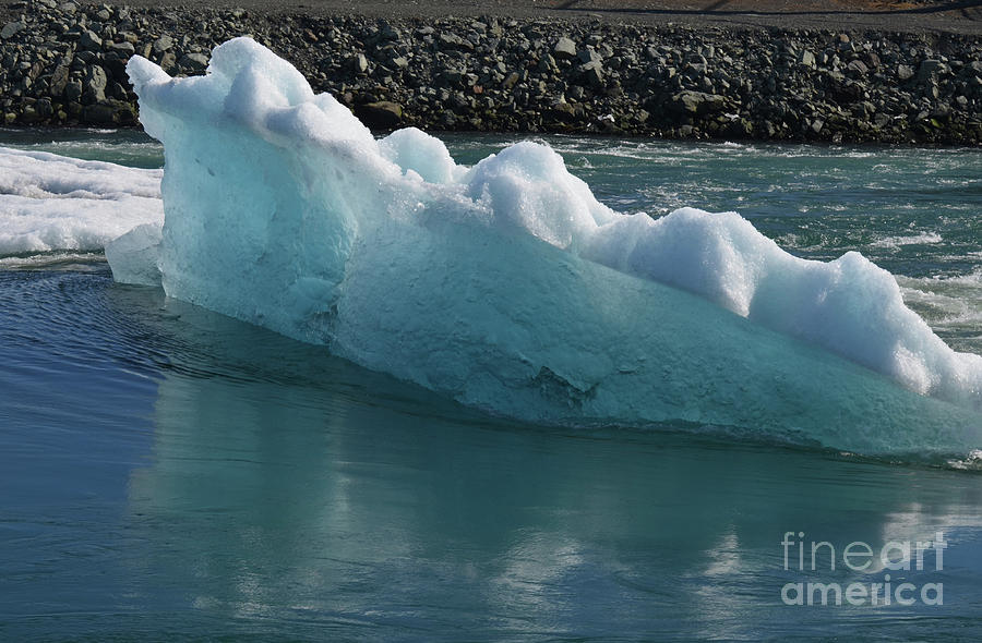 Iceberg in Jokulsarlon floating in a lagoon Photograph by DejaVu Designs