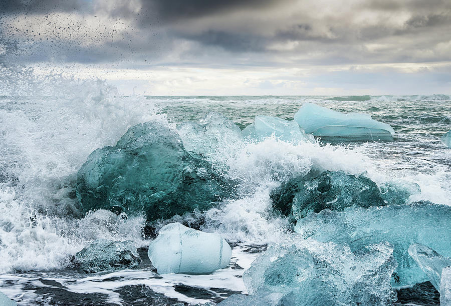 Icebergs and crashing waves in Iceland Photograph by Matthias Hauser
