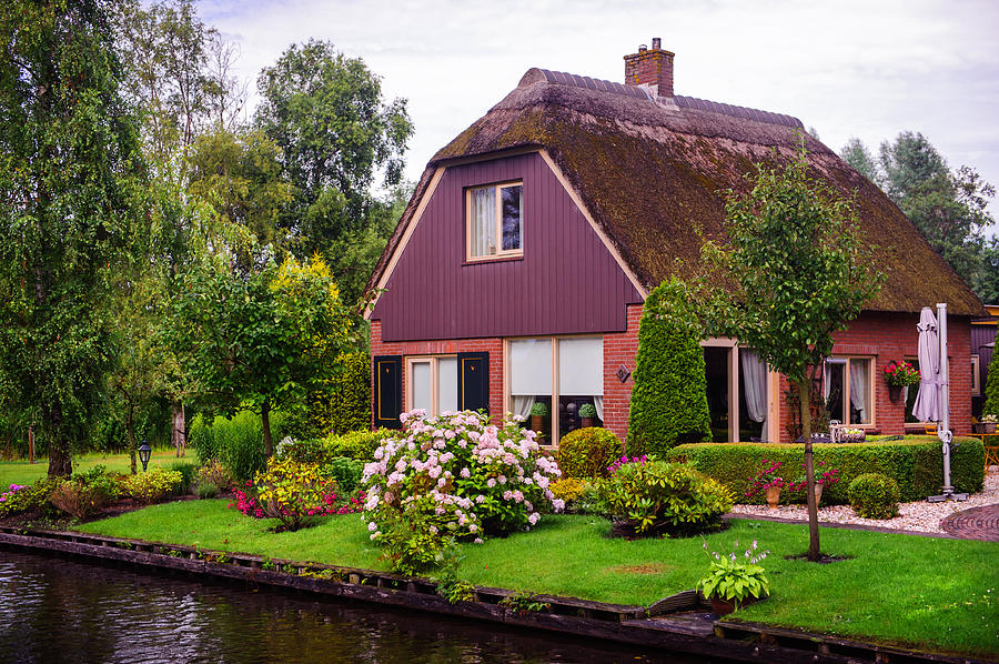 Idyllic Cottage at the canal in Giethoorn Photograph by Jenny Rainbow