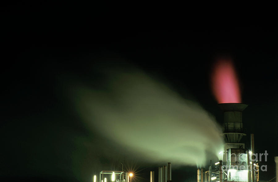 Building Photograph - Illuminated chimney at a petroleum refinery by Sami Sarkis