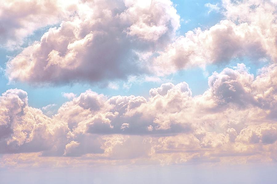 Illuminated Fluffy Pink Clouds In A Blue Sky Photograph By Artpics