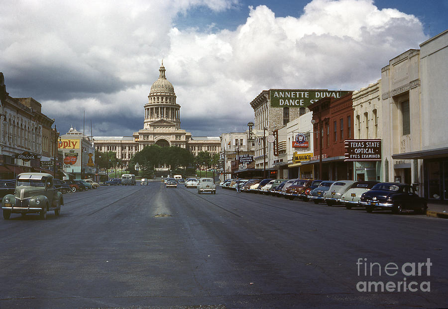 Austin Photograph - In this historical 1950 photo, cars line up and down Congress Avenue in downtown Austin, Texas by Dan Herron