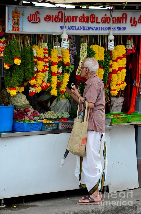 Indian man stands at Little India flower garland shop Singapore Photograph by Imran Ahmed