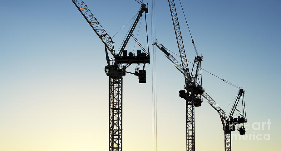 Construction Cranes at Sunset Silhouette #1 Photograph by Tim Gainey
