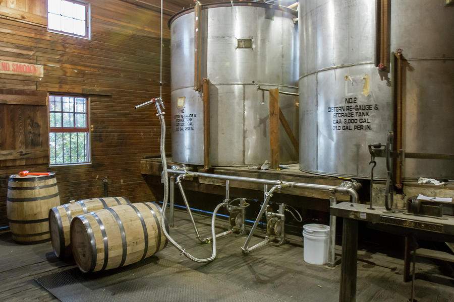 Inside barrel filling room of distillery Photograph by Karen Foley