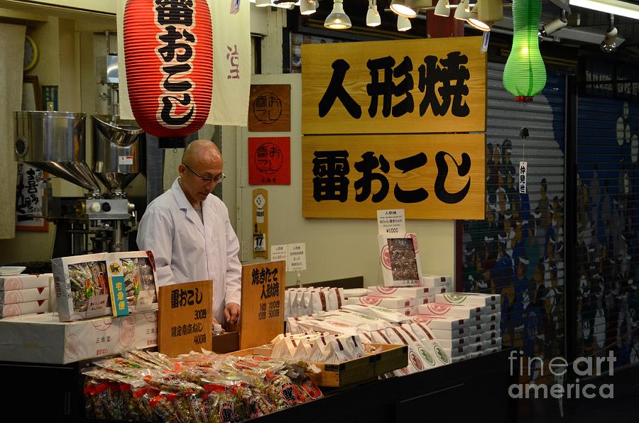 Japanese store owner mans Tokyo shop after dark Photograph by Imran Ahmed