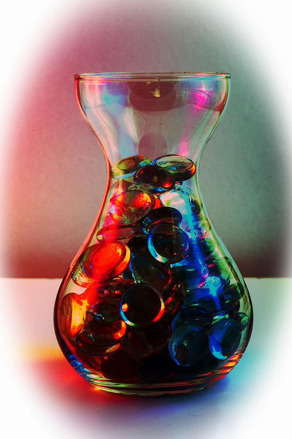 Jar of darkly coloured glass pebbles. Photograph by John Paul Cullen