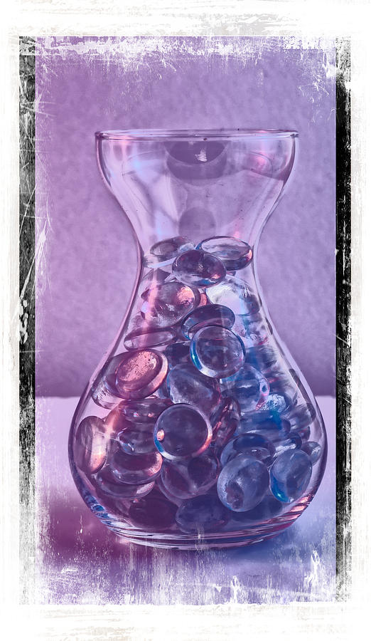 Jar of glass pebbles in hues of blue and purple. Photograph by John Paul Cullen