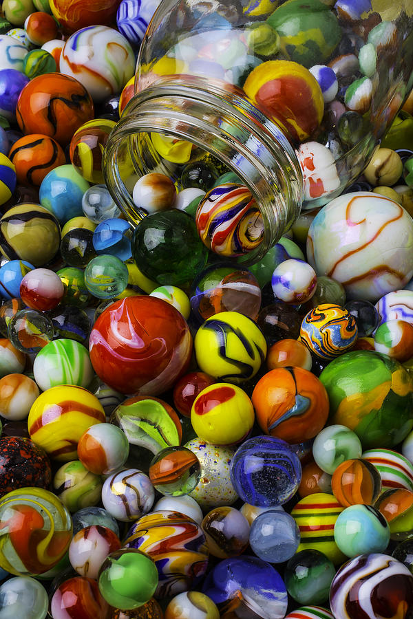 Jar Pouring Out Glass Marbles Photograph by Garry Gay