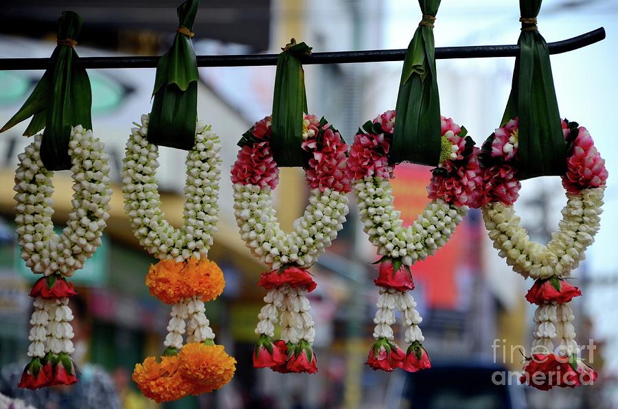 Jasmine and rose flower garlands hang with leaves in bazaar Hatyai Thailand Photograph by Imran Ahmed