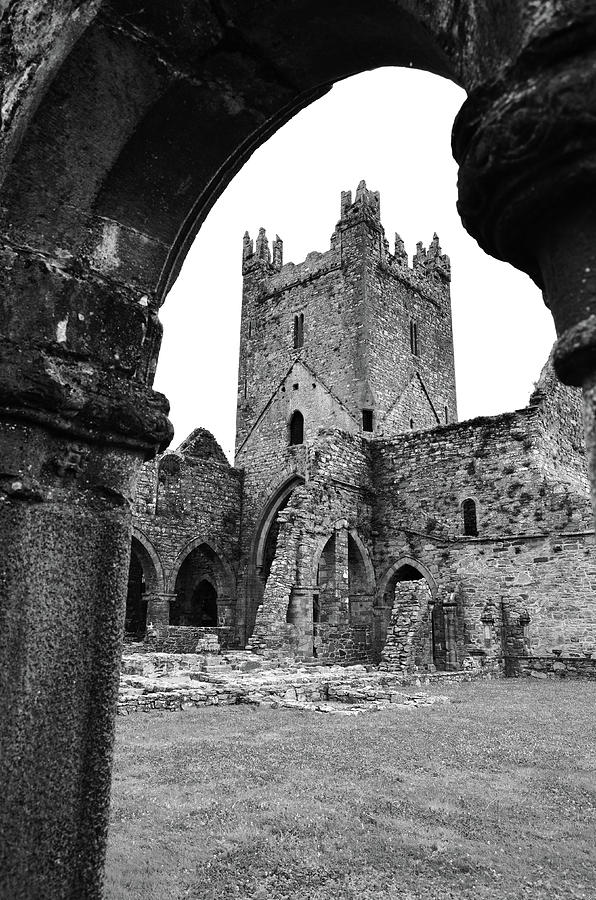 Jerpoint Abbey Ruins Ireland Tower and Arched Cloister Column County Kilkenny Black and White Photograph by Shawn OBrien