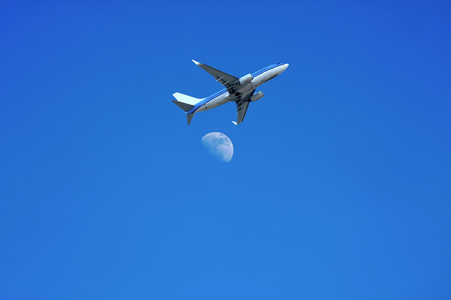 Jet plane flying over the moon Photograph by Steve Ball