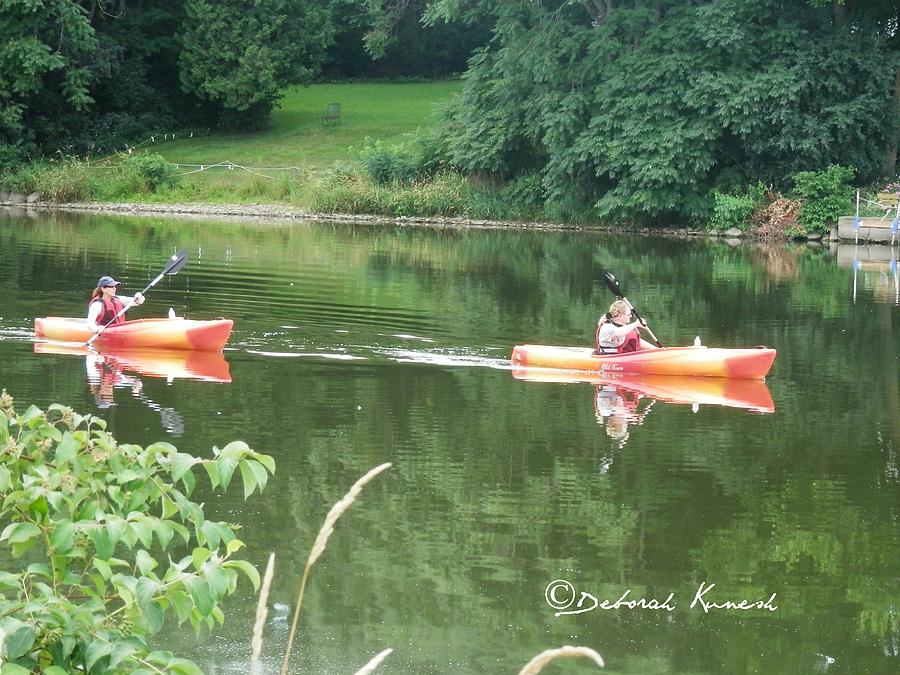 Kayaks on the River Photograph by Deborah Kunesh