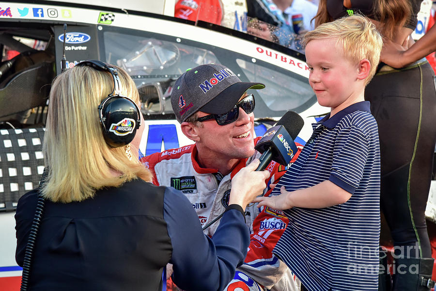 Kevin Harvick being interviewed with his son Kelaan after his recent victory at Texas Motor Speedway Photograph by Paul Quinn