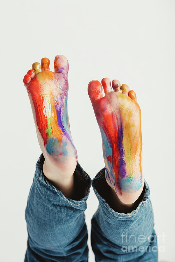 Kids feet painted in rainbow colors. Photograph by Michal Bednarek